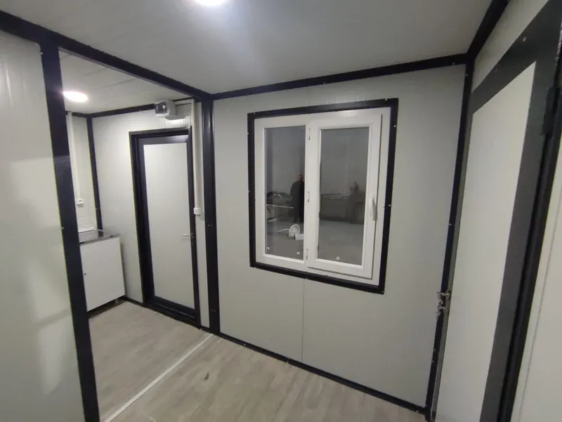 Interior of a B2KON mobile office with a double-glazed window and a steel door