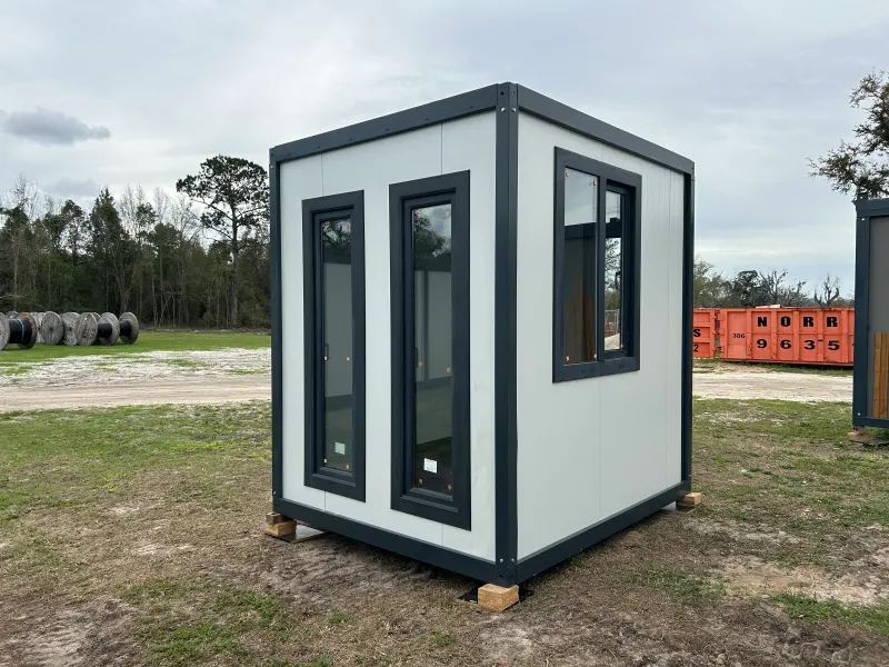 UNIMOD 6.5 by 8 foot guard shack with tall windows and a steel door